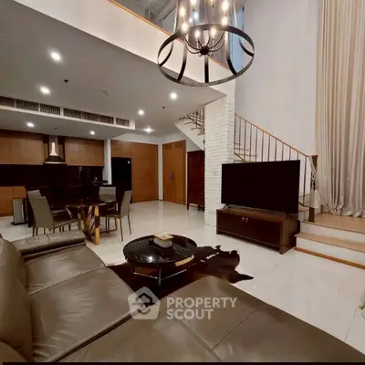 Luxurious modern living room with high ceilings and elegant chandelier