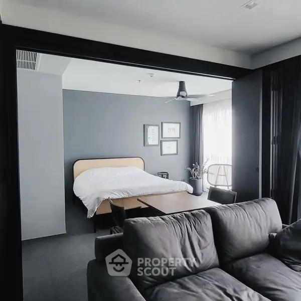 Modern open-plan bedroom with stylish decor and natural light