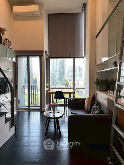 Modern loft apartment with high ceilings, large windows, and stylish decor in urban setting.