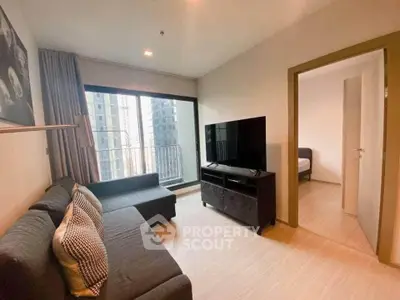 Modern living room with large TV and city view balcony in urban apartment