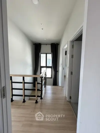 Modern hallway with wooden flooring and natural light