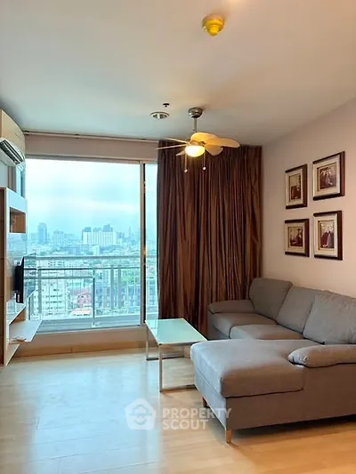 Modern living room with city view, cozy sofa, and stylish decor