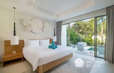 Luxurious bedroom with pool view and modern decor, perfect for relaxation.