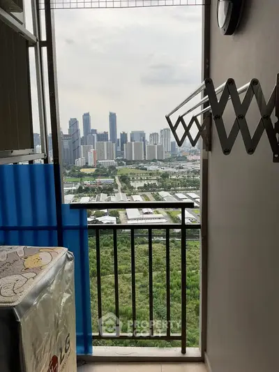 Balcony with city skyline view and laundry area in modern apartment