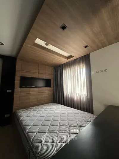 Modern bedroom with stylish wood paneling and natural light