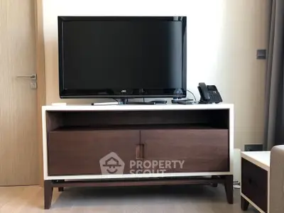Modern living room with sleek TV stand and flat-screen TV, perfect for entertainment setup.