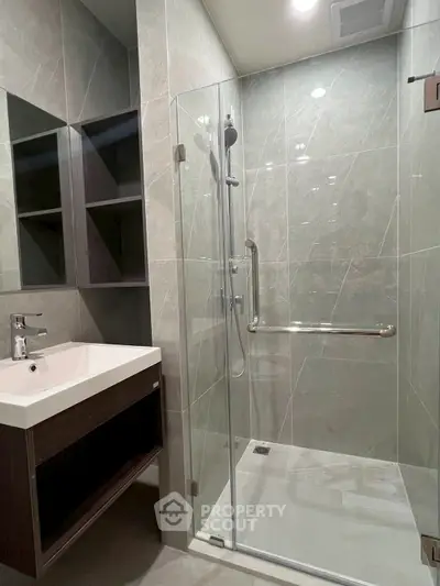 Modern bathroom with glass shower enclosure and sleek vanity