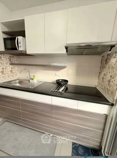 Modern kitchen with sleek cabinetry and built-in appliances