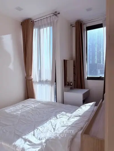 Bright bedroom with large windows and modern decor