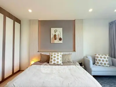 Elegant bedroom with modern decor and cozy seating area