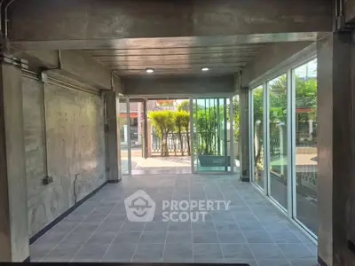 Spacious modern room with large windows and garden view, perfect for versatile living space.