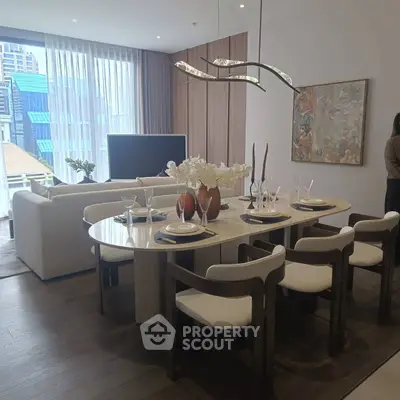 Luxurious open-plan living and dining area with modern decor and large windows.