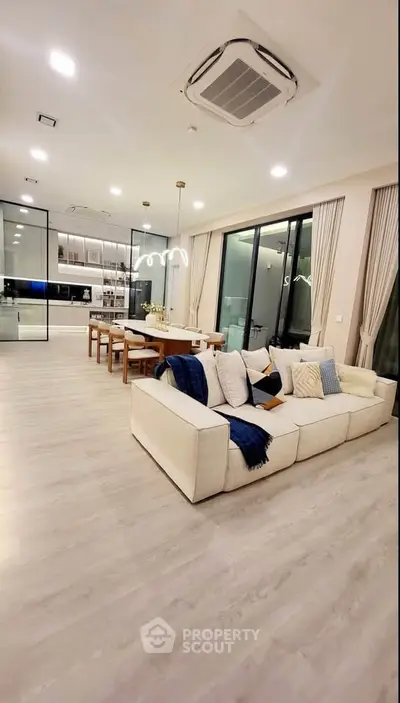 Spacious modern living room with elegant dining area and large windows