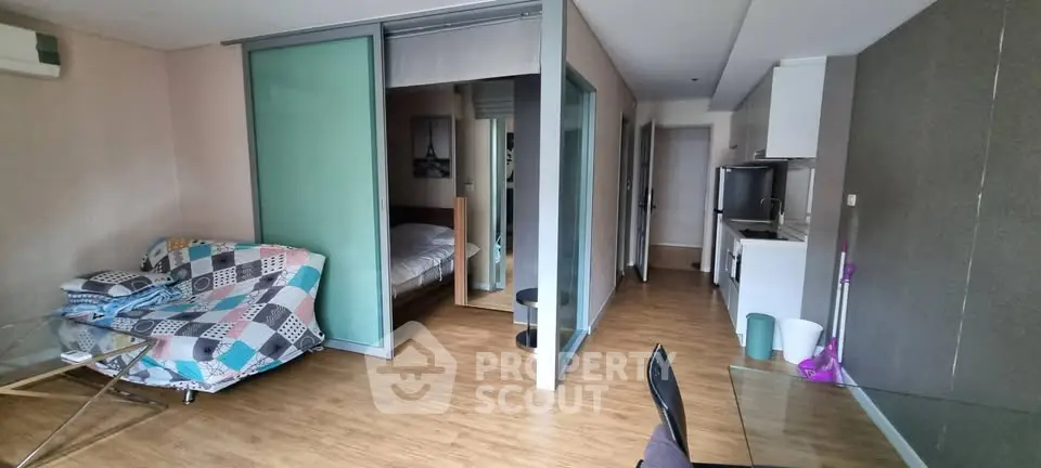 Modern studio apartment with open layout and stylish glass partitions.