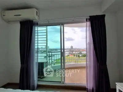 Spacious bedroom with balcony offering stunning cityscape views