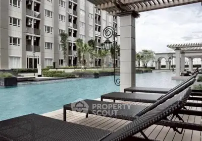 Luxurious apartment complex with stunning poolside view and modern architecture.
