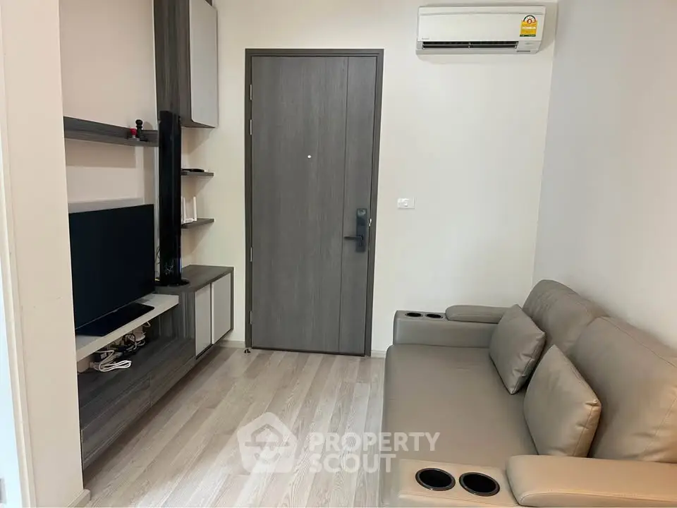 Modern living room with sleek furniture and air conditioning, perfect for cozy urban living.