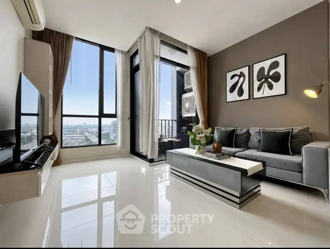 Modern living room with panoramic city view, sleek furniture, and elegant decor in a high-rise apartment.