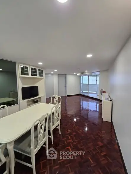 Spacious living room with elegant dining area and polished wooden floors