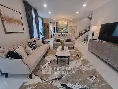 Luxurious living room with elegant decor, plush sofas, and a stunning chandelier, perfect for sophisticated gatherings.