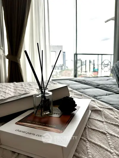 Cozy bedroom with elegant decor and city view from the balcony.