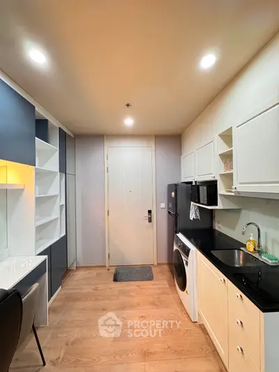 Modern kitchen with sleek cabinetry and integrated appliances in a stylish apartment