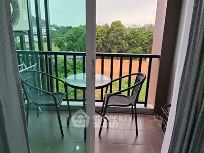 Charming balcony with cozy seating and lush green view, perfect for relaxation and enjoying nature.
