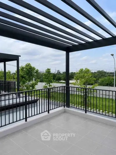 Spacious balcony with modern railing and scenic view of greenery, perfect for relaxation and outdoor enjoyment.