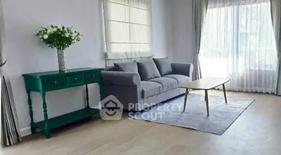 Spacious living room with modern gray sofa and elegant decor