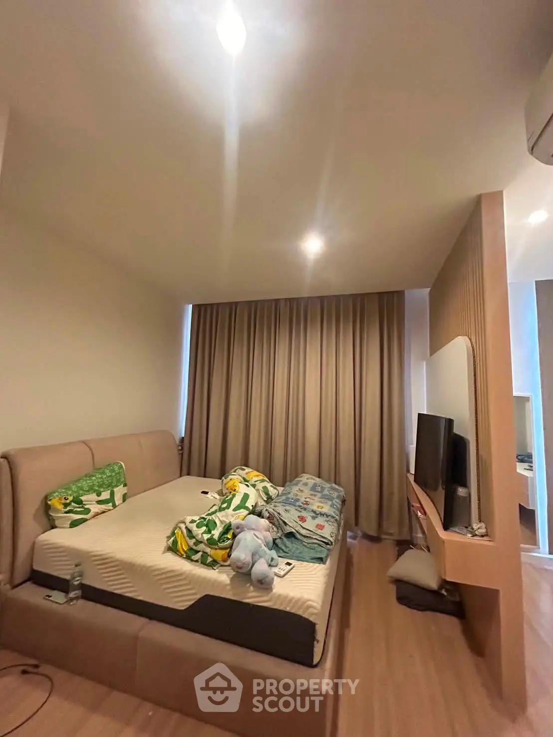 Cozy bedroom with modern decor and natural light, featuring a comfortable bed and stylish furnishings.