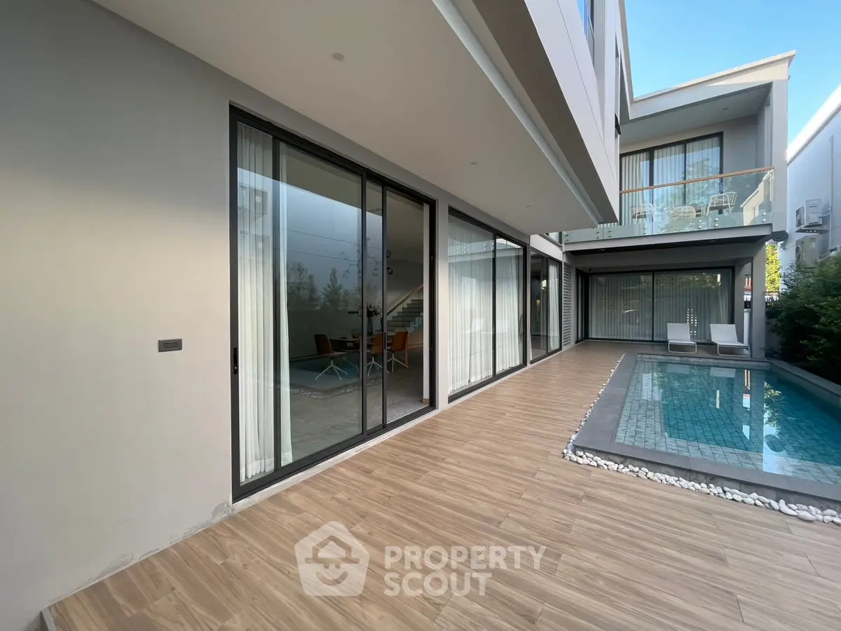 Modern home with poolside patio and glass sliding doors