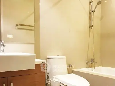 Modern bathroom with bathtub and sleek fixtures in a contemporary apartment.