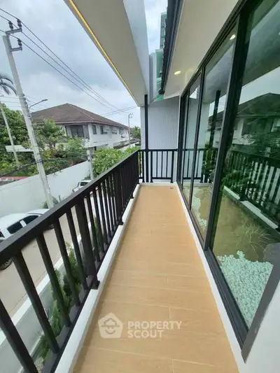 Spacious balcony with modern railing and scenic neighborhood view