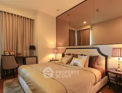 Luxurious bedroom with elegant decor and ambient lighting, featuring a plush bed and stylish furnishings.