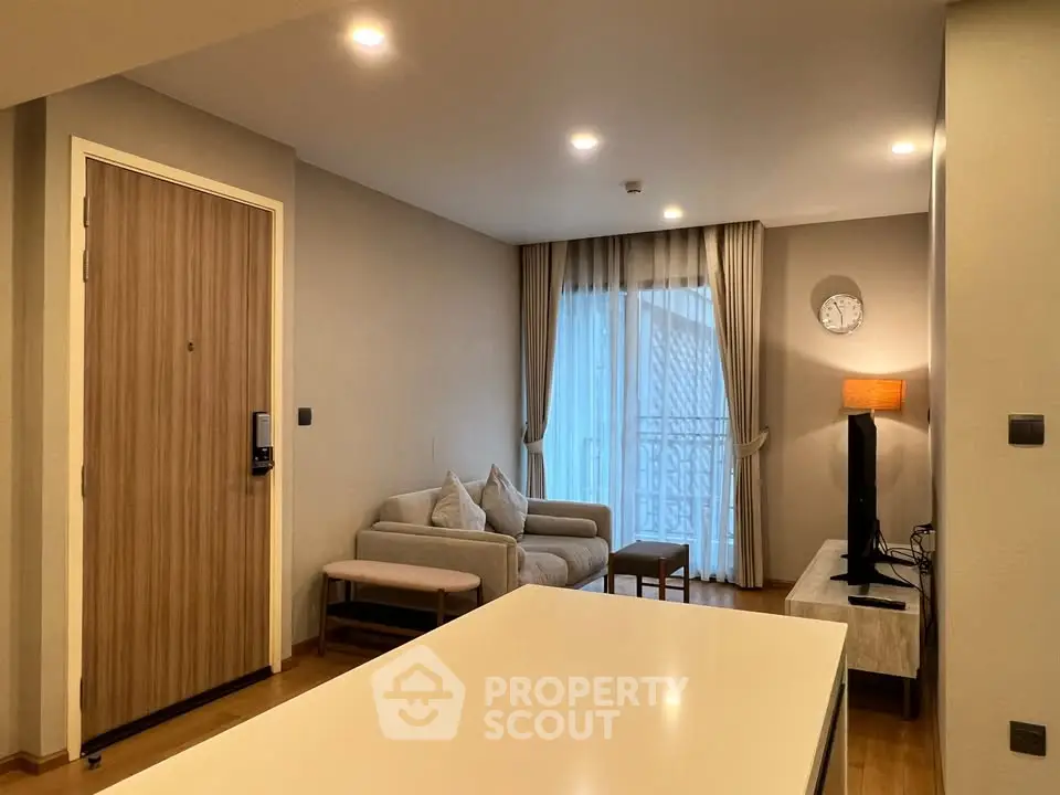 Modern living room with cozy sofa, stylish decor, and balcony view in a contemporary apartment.