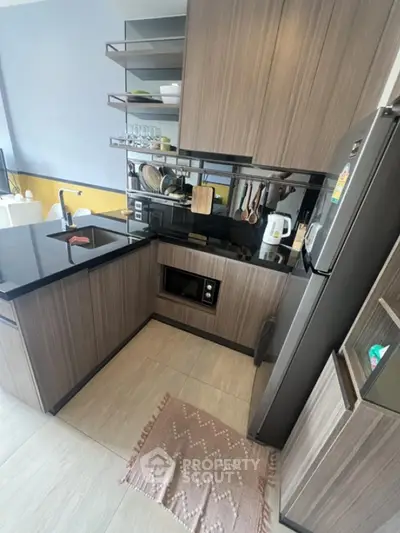 Modern kitchen with sleek cabinetry and built-in appliances in a compact layout.