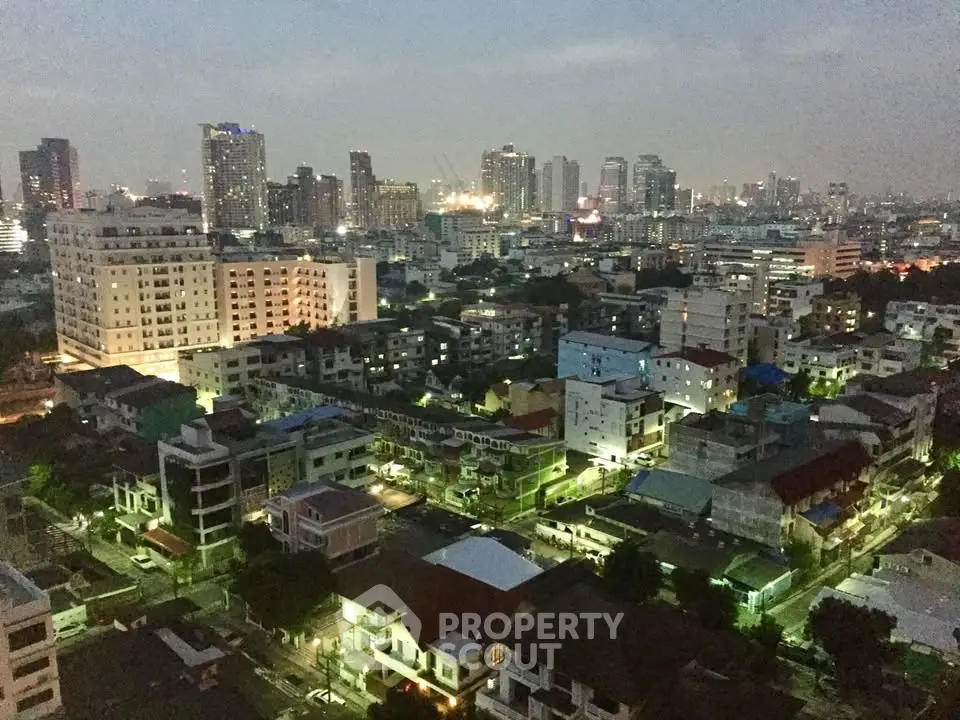 Stunning cityscape view showcasing vibrant urban skyline at dusk with illuminated buildings.