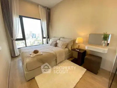 Luxurious bedroom with city view, featuring elegant decor and large windows for natural light.