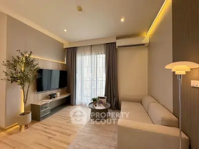 Modern living room with sleek design, featuring a cozy sofa, flat-screen TV, and elegant lighting.