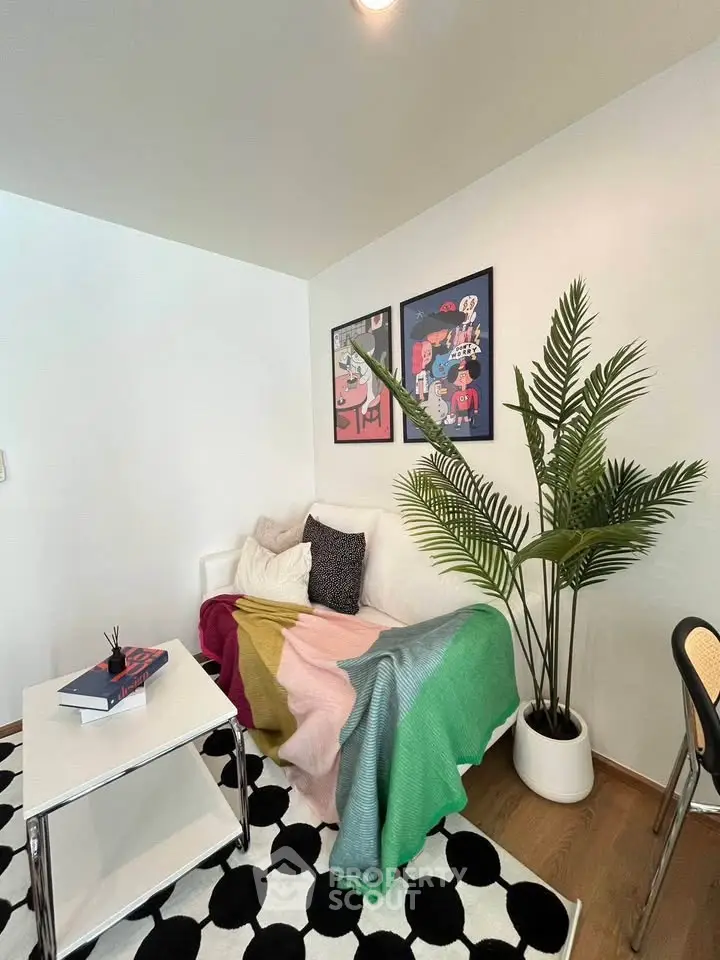 Stylish living room with modern decor, vibrant artwork, and cozy seating area.