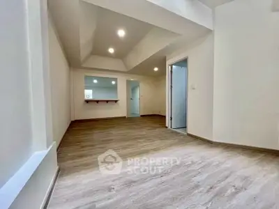 Spacious modern living room with wooden flooring and recessed lighting
