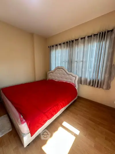 Cozy bedroom with elegant bed and natural light, perfect for relaxation.
