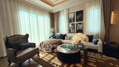Luxurious living room with elegant decor, plush seating, and large windows for natural light.