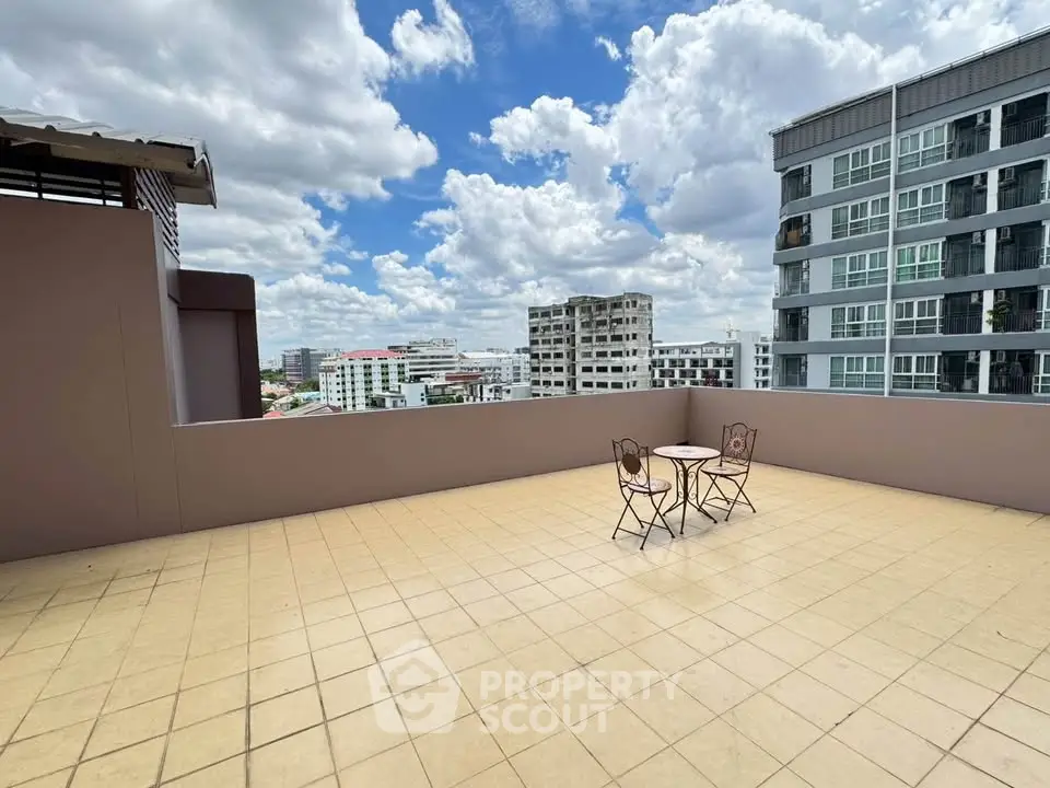 Spacious rooftop terrace with city views and outdoor seating, perfect for relaxation and entertainment.