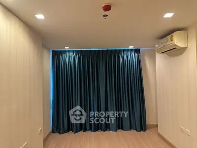 Spacious room with elegant curtains and modern air conditioning unit