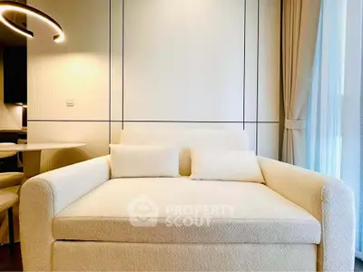 Modern living room with stylish sofa and elegant lighting, perfect for cozy relaxation.
