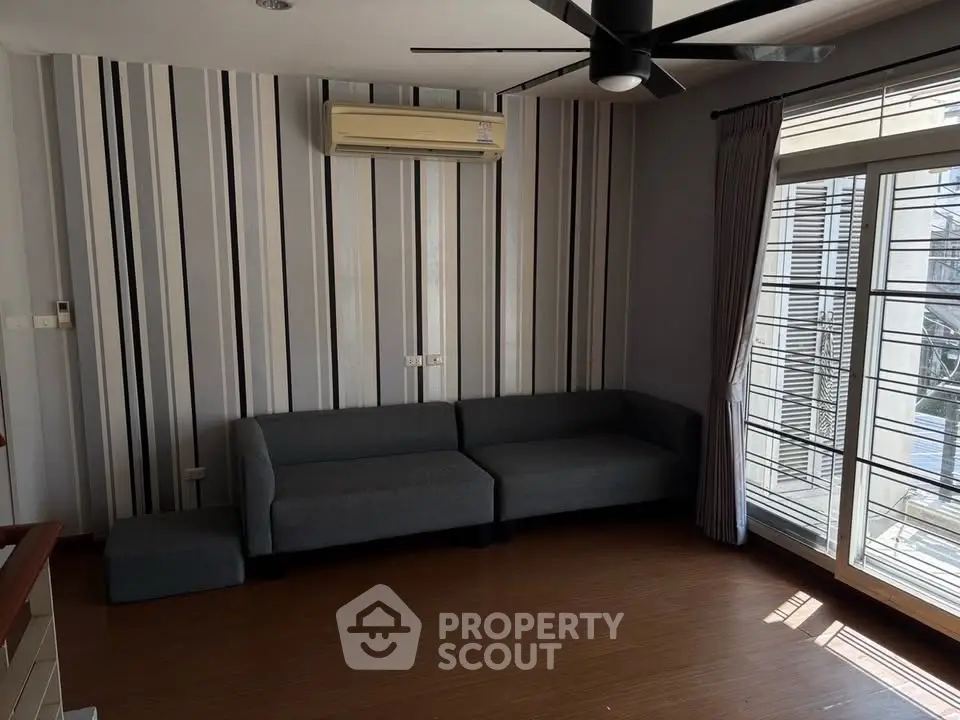 Modern living room with stylish striped wallpaper and large window