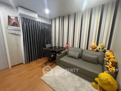 Cozy living room with stylish striped wallpaper and comfortable seating