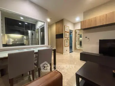 Modern living room with dining area and sleek kitchen view