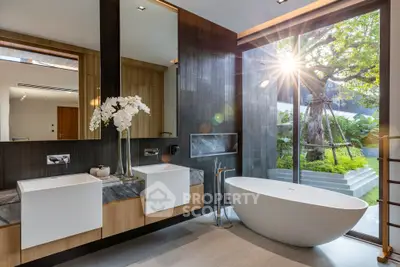 Luxurious modern bathroom with freestanding tub and garden view